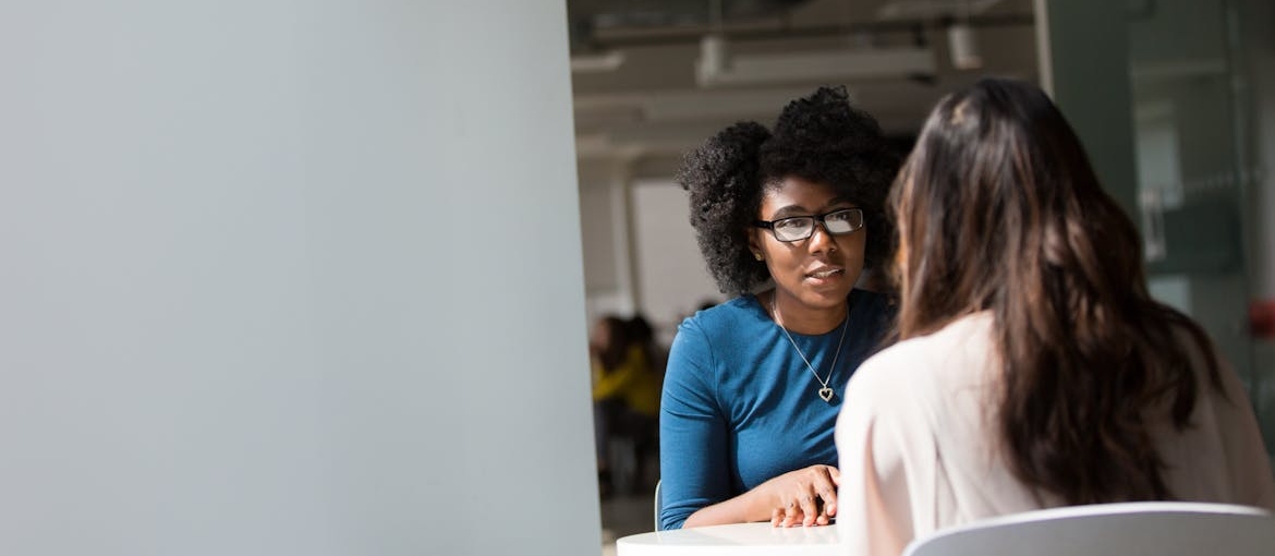 Two women having a serious conversation.