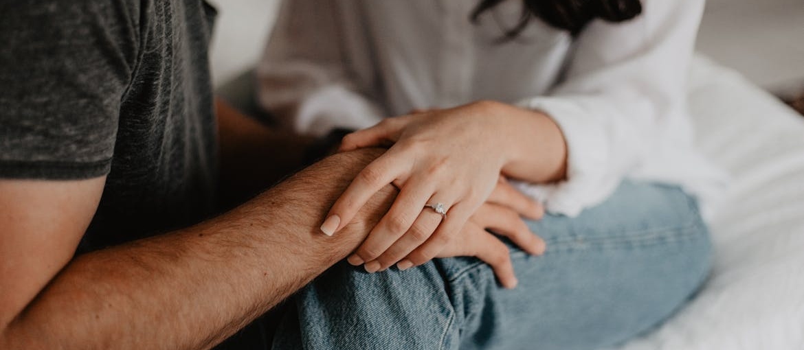 Woman holding her husband's hand.