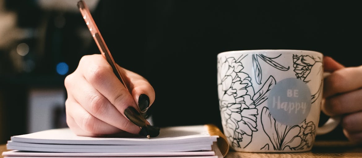 Woman writing in her notebook.