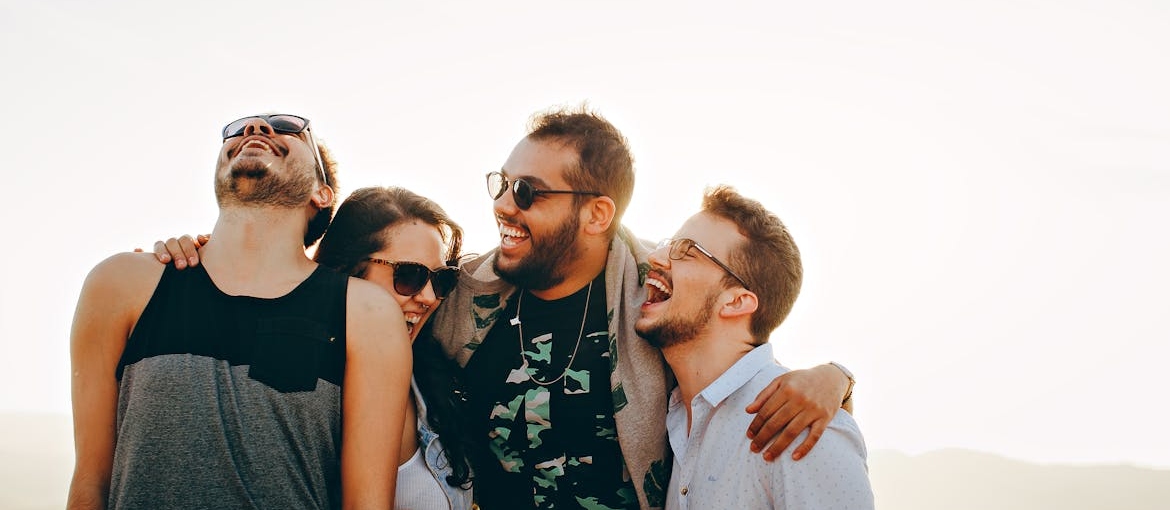Four people hugging each other.