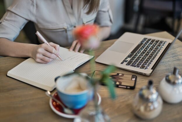 Woman writing in her notebook.