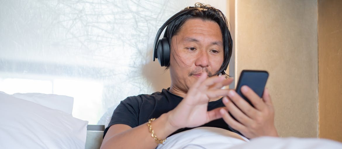 Man listening to best stress management books.
