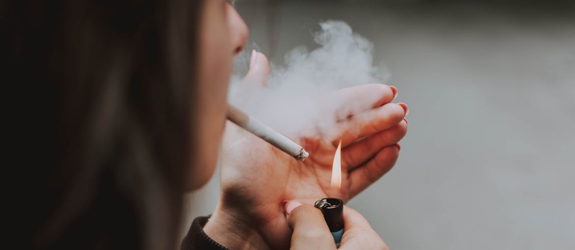 Woman smoking cigarettes, one of the more popular gateway drugs.