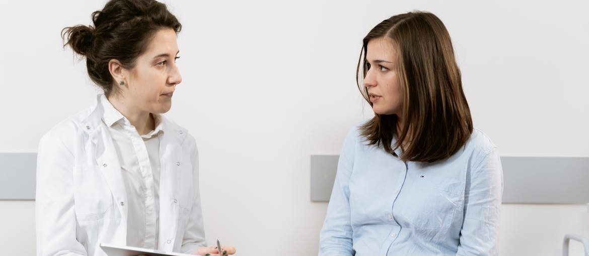 Doctor explaining when to stop smoking weed while pregnant to her patient.