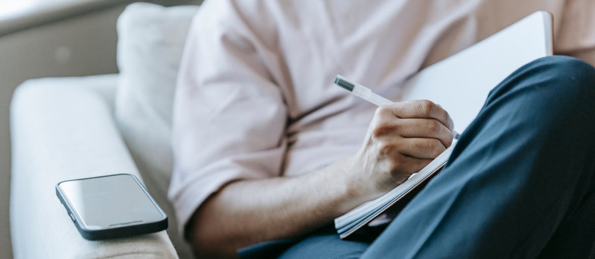 Man journaling to avoid the stages of relapse.