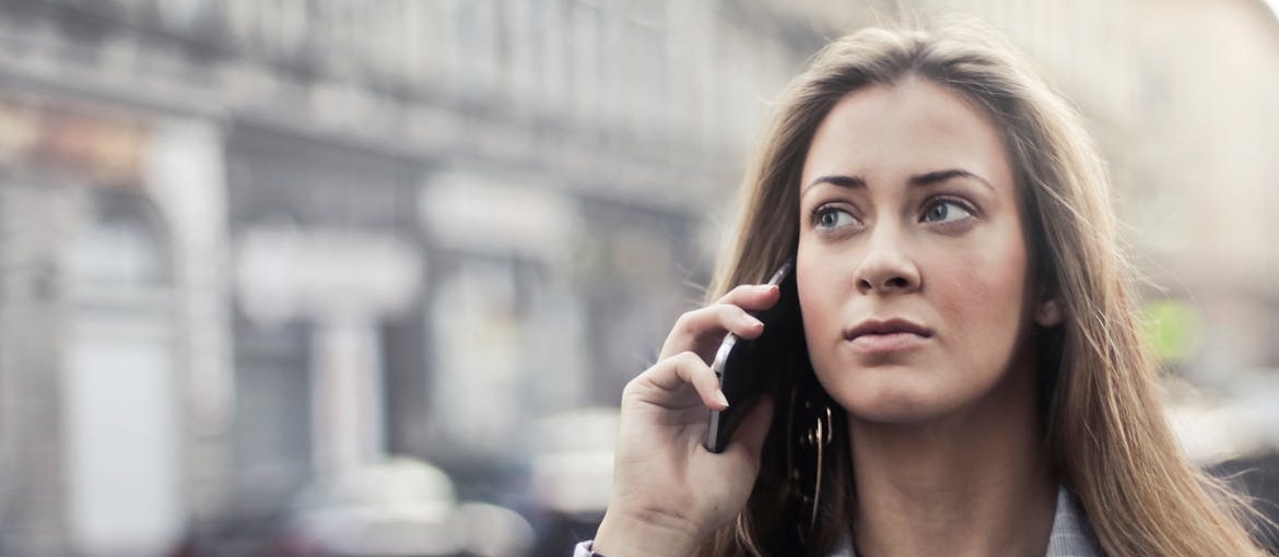Woman making a phone call in the street.