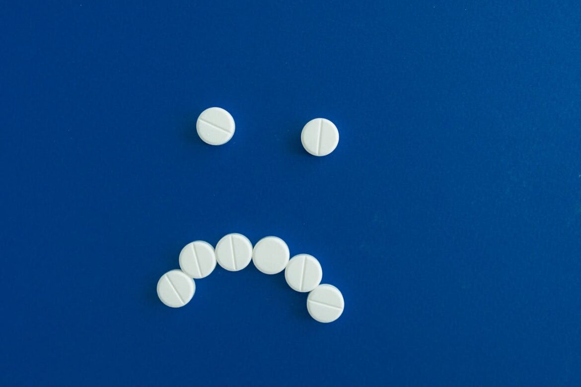 White pills forming a frown.