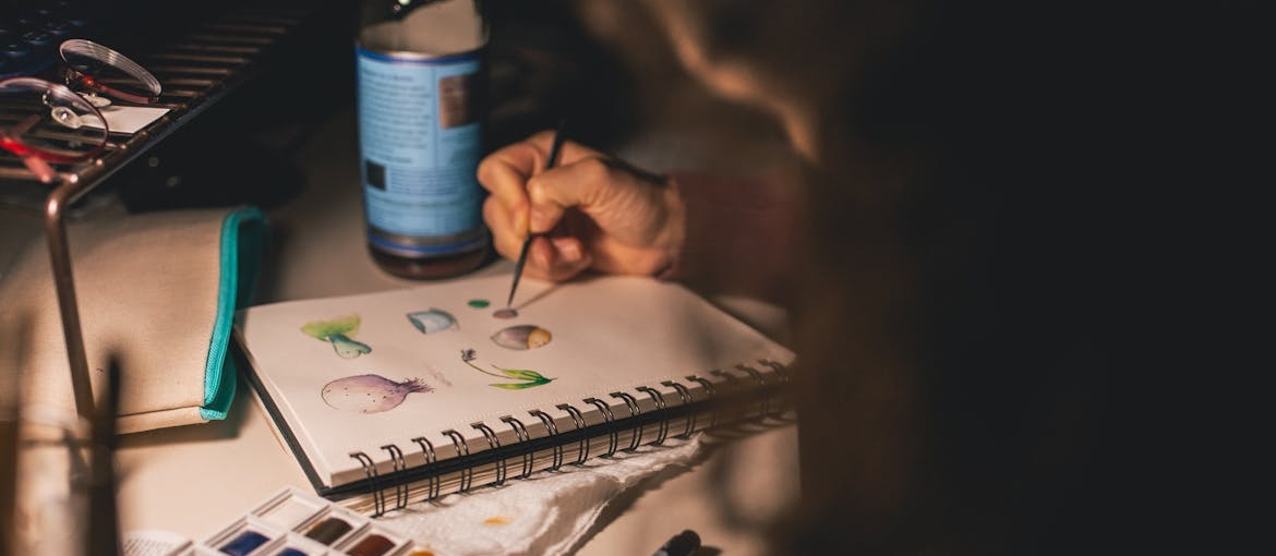 Person coloring in their notebook.