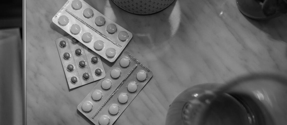 Blisters of pills on a coffee table.