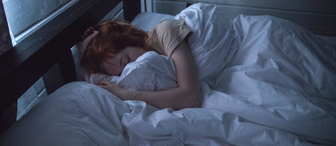 Woman sleeping in her bed.