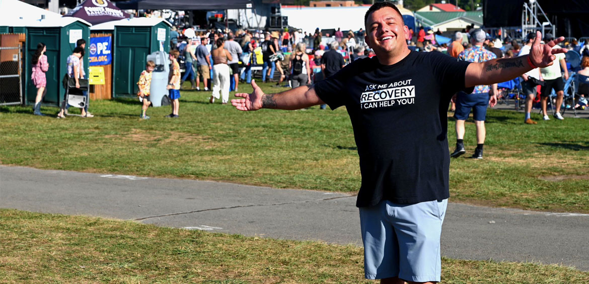 a boy in tshirt that says Ask Me About Recovery, I Can Help You