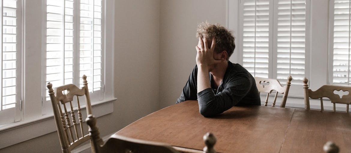 Man sitting at the kitchen table.