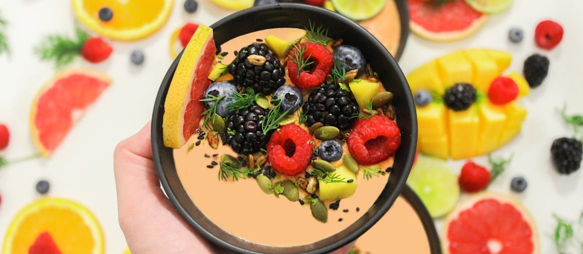Person holding an acai bowl.