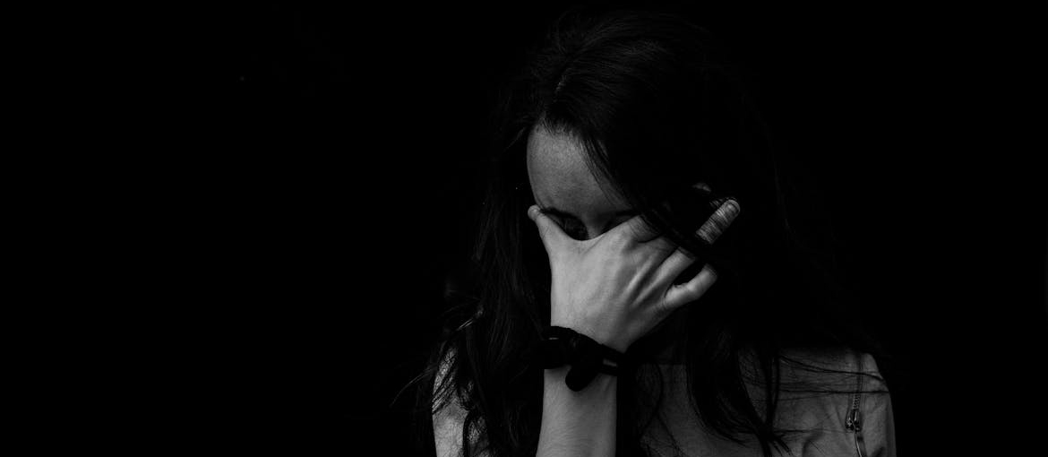 Woman experiencing anxiety while thinking about can you overdose on DMT.