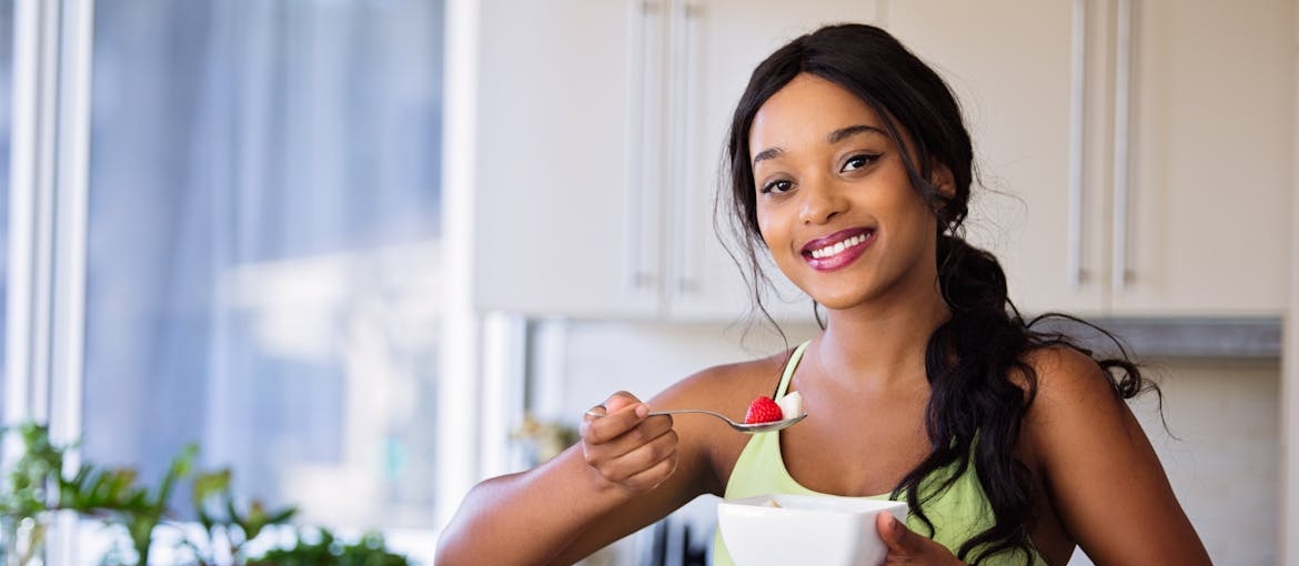 Woman eating a fruit salad.