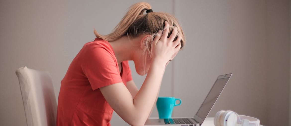 Stressed out woman looking at her laptop.