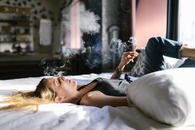Woman smoking weed while living a California sober lifestyle.