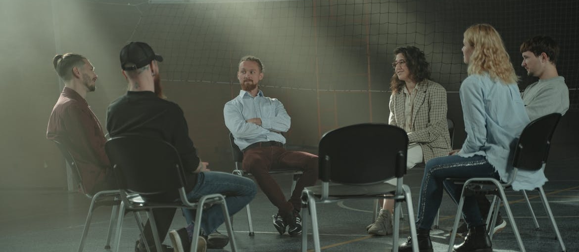 People in a support group discussing their struggles.