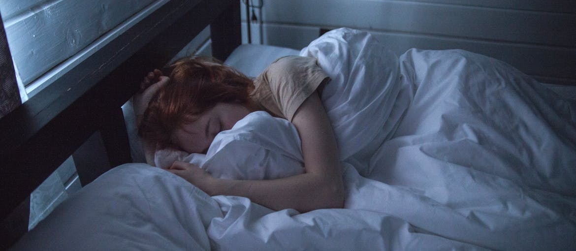 Woman sleeping in her bed.
