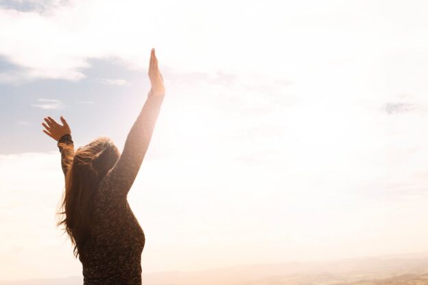 Woman lifting her hands towards the sky.