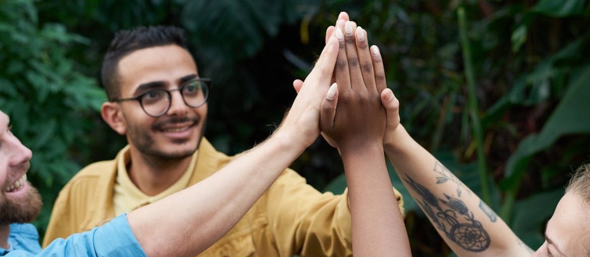 Group of friends high fiving.