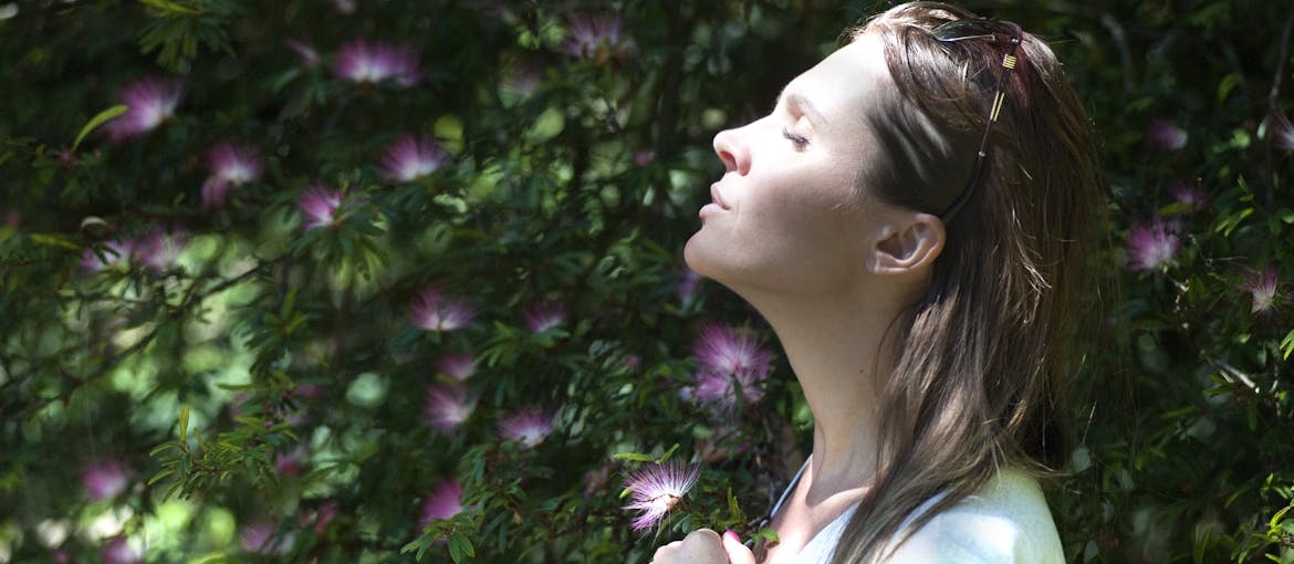 Woman practicing mindful breathing exercises.