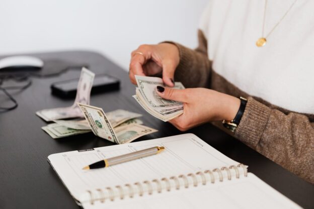 Person budgeting and practicing money management in addiction recovery.