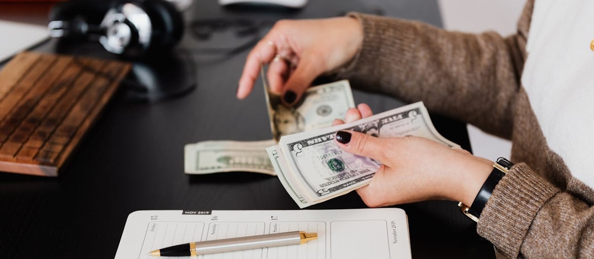Person budgeting and practicing money management in addiction recovery.