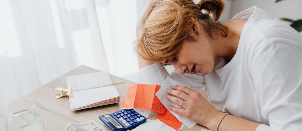 Woman crying while looking at her healthcare bills.
