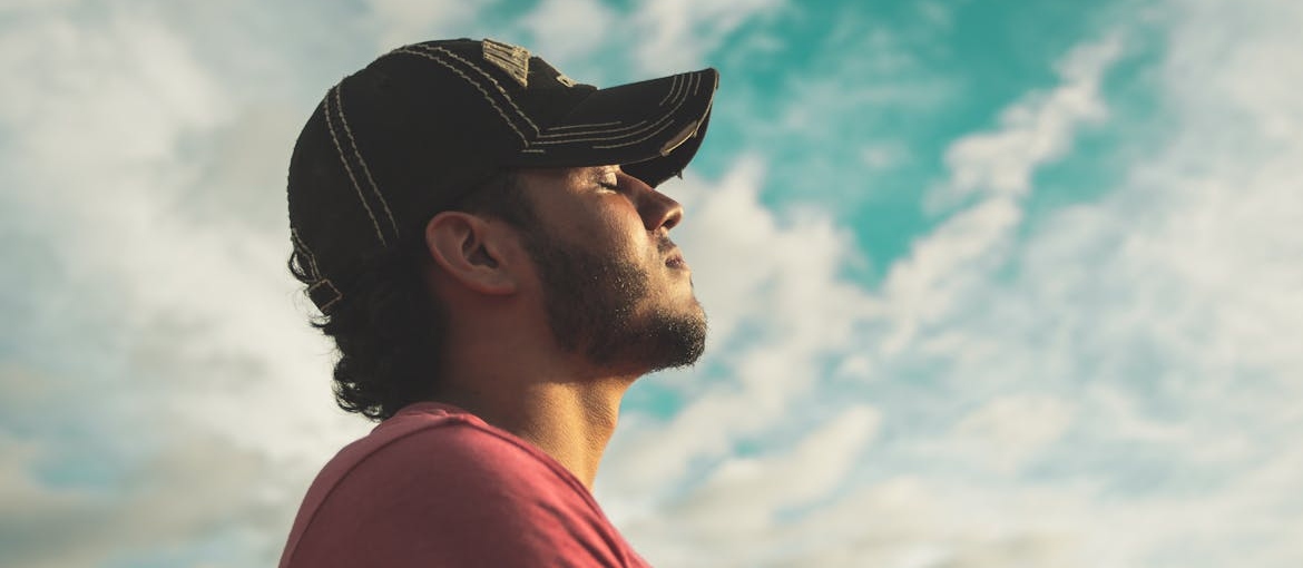 Man closing his eyes and enjoying mental wellness.