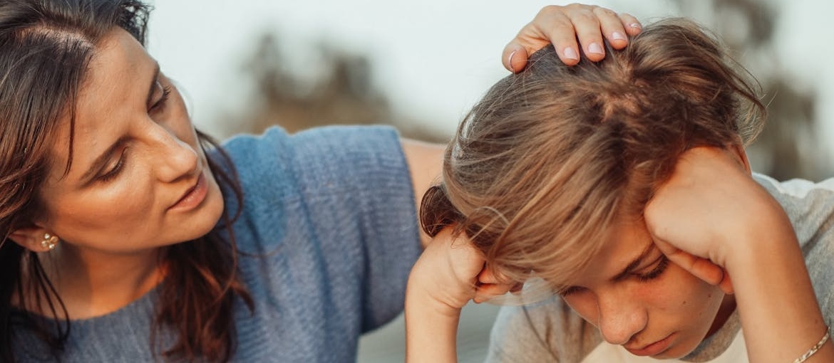 Woman helping a child whose parent is struggling with addiction.