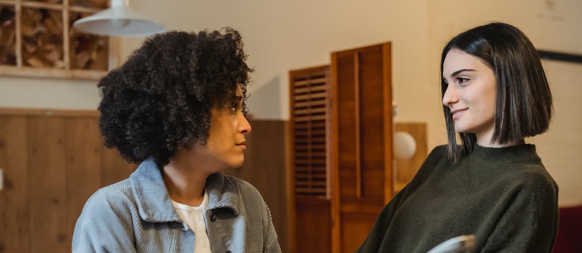 Two women having a serious conversation.