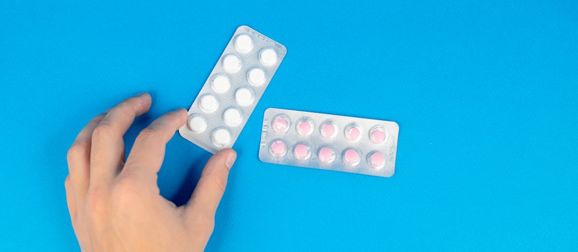 Person holding a blister of pills.