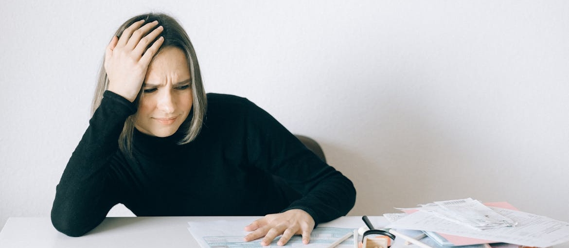 Woman worrying about unpaid bills.