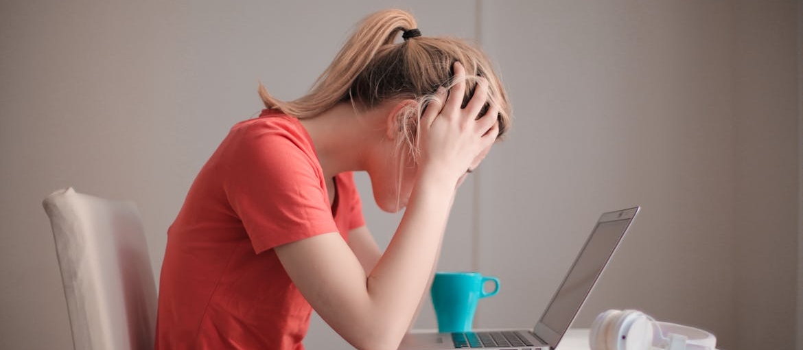 Stressed out woman looking at her laptop.