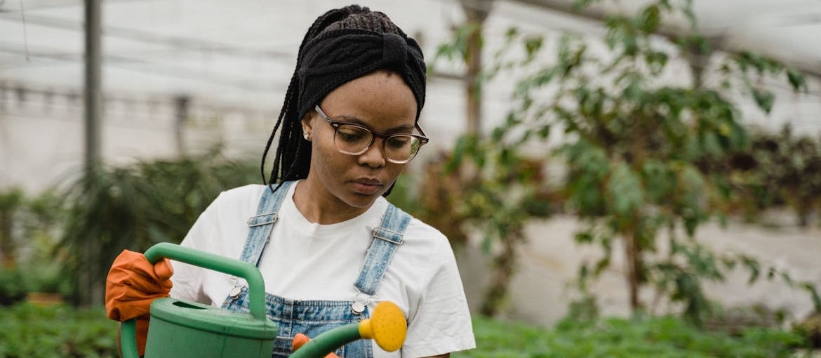 Woman watering flowers while gardening.