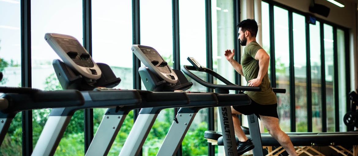 Man running on a treadmill in the gym.