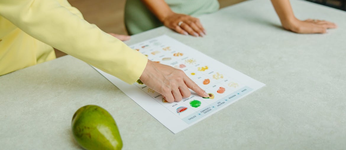 Nutritionist pointing to a meal plan.