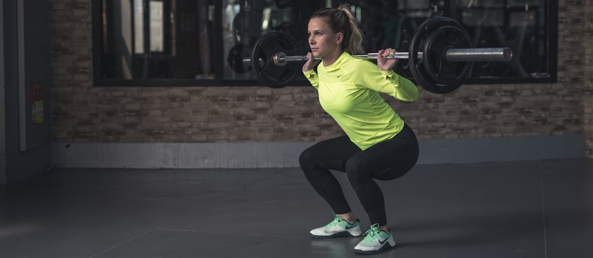 Woman lifting weights and exercising.