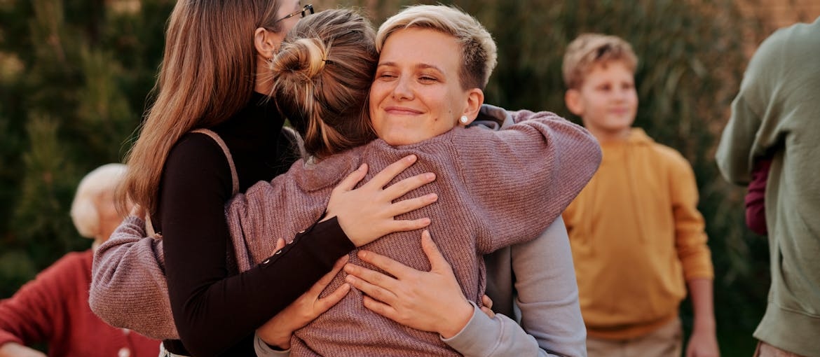 Family members hugging each other.