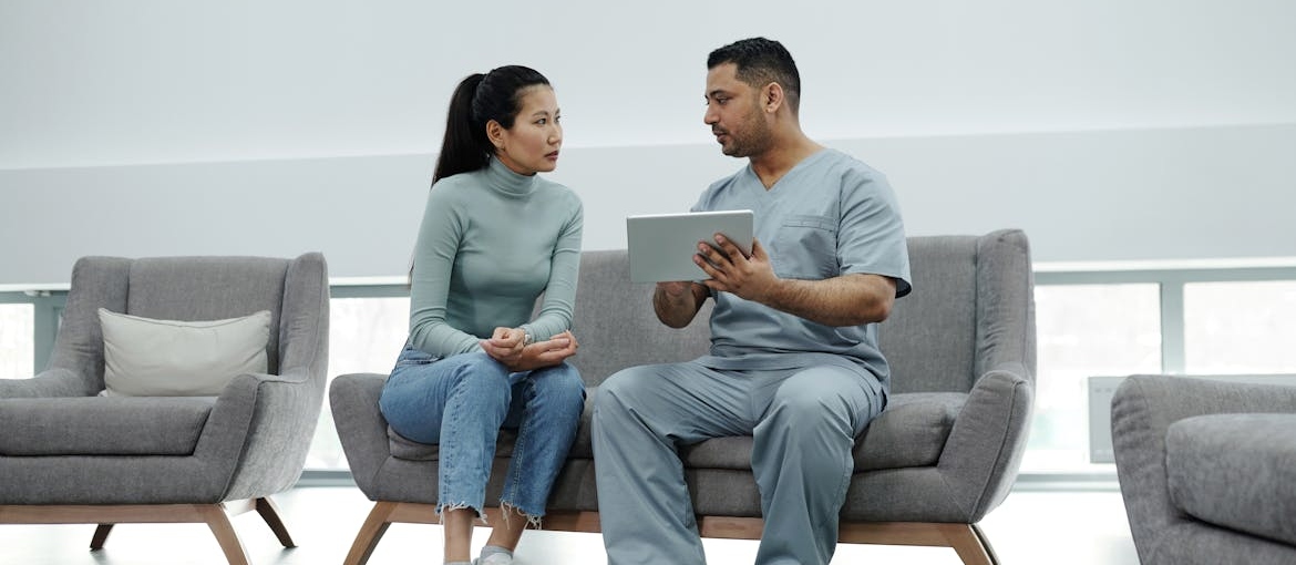 Woman talking to a doctor.