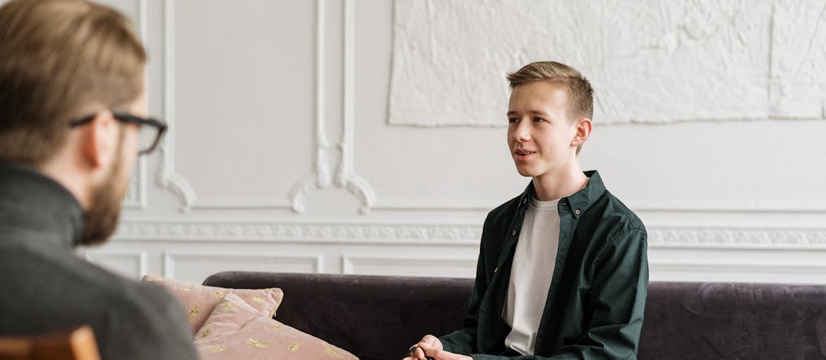 Young man talking about his issues with ADHD and MDMA use with a therapist.