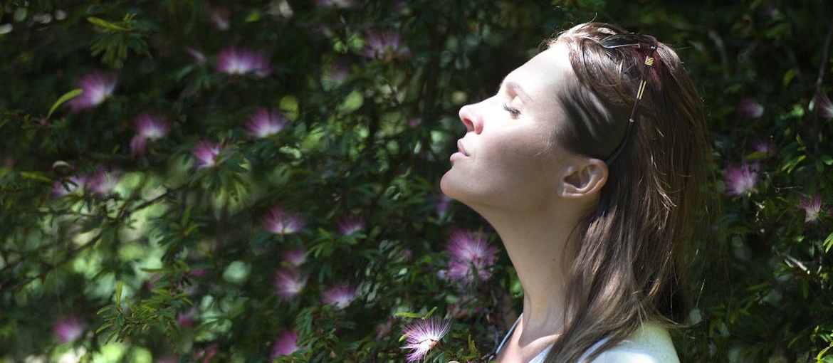 Woman practicing mindful breathing as a coping mechanism.
