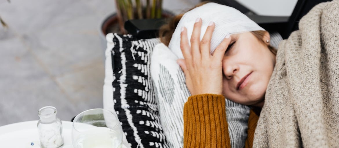 Woman lying in bed and experiencing Xanax withdrawal symptoms.