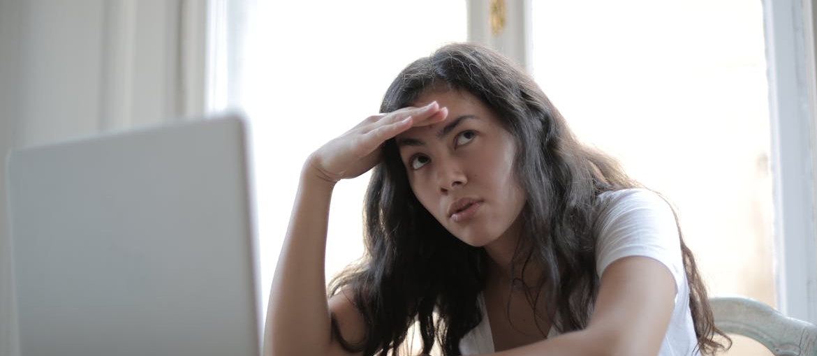 Woman looking at her laptop and having concentration problems.