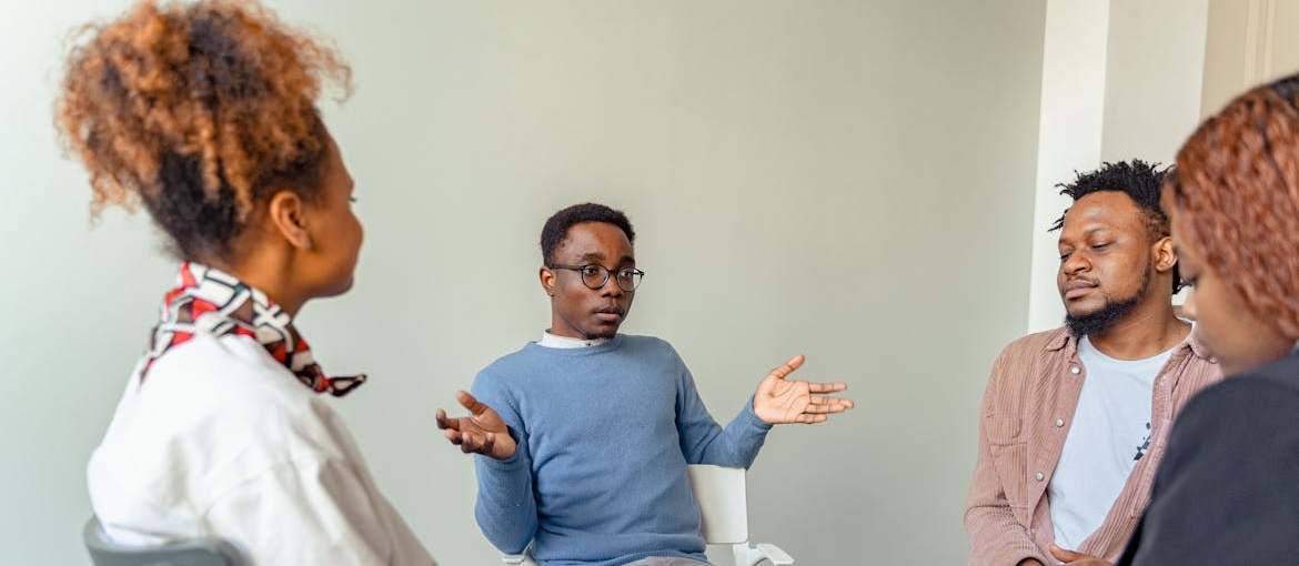 People in a support group talking about how to help an alcoholic loved one.