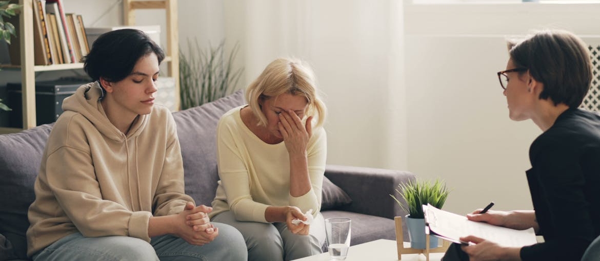 People in family therapy discussing the link between genetics and addiction.