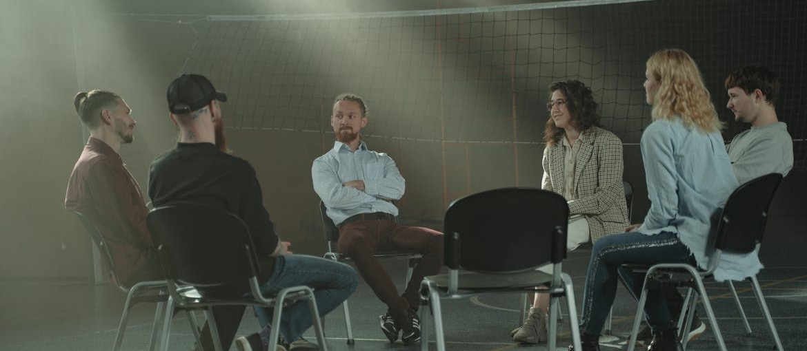 People sitting in a circle and discussing their issues.