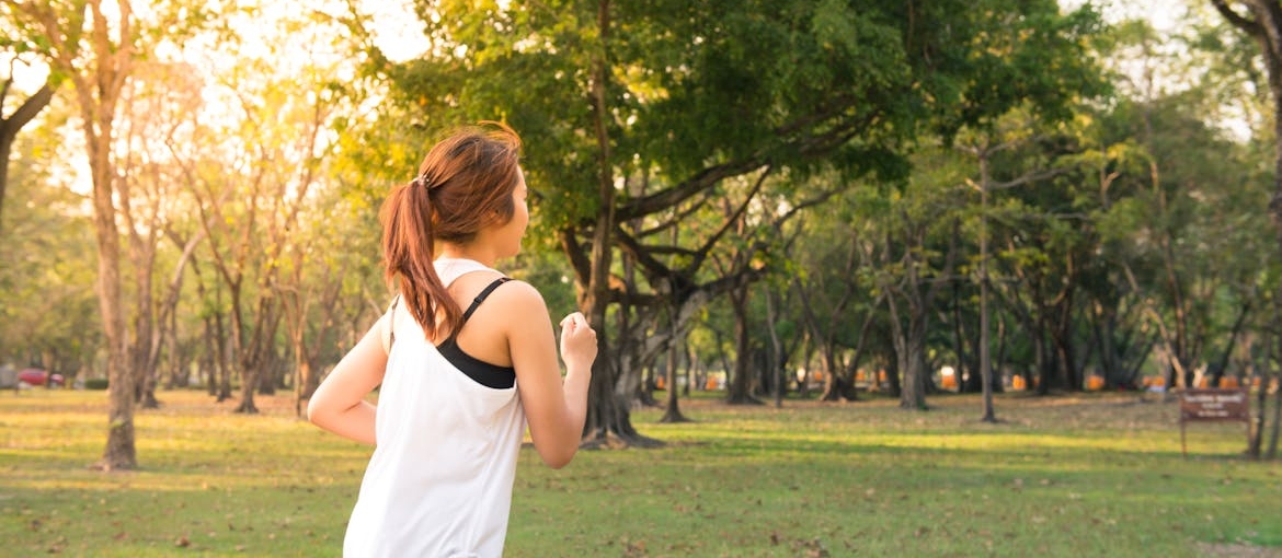 Woman jogging in a park.