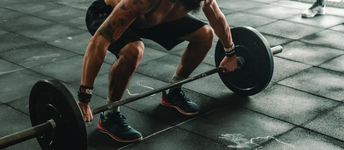 Man lifting weights with barbells.